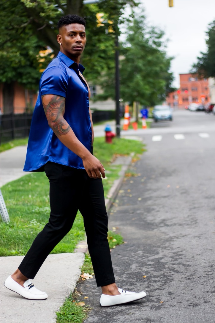 blue shirt black pants walking